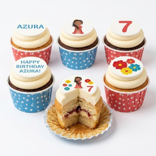 Birthday cupcakes with girl character, custom age topper, and floral designs.