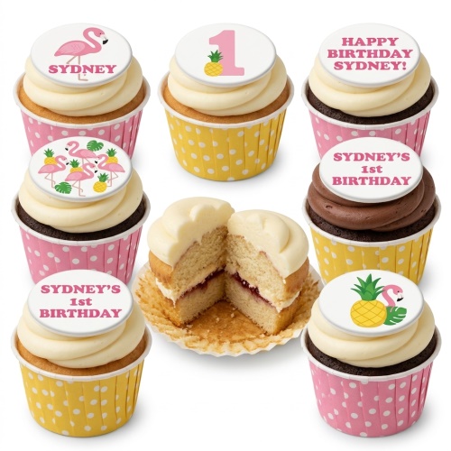 Cupcakes with pink flamingo and pineapple toppers, some with custom age and birthday messages, in pink and yellow polka dot cases.