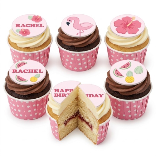 Set of six tropical themed cupcakes with flamingo, hibiscus, watermelon, and pineapple toppers on pink polka dot wrappers.