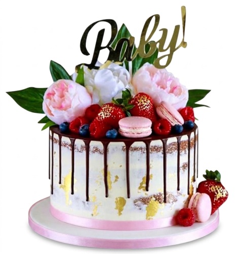 Round semi-naked baby shower cake with chocolate drip, gold leaf, pink and white flowers, mixed berries, and pink macarons, topped with 'Baby!'.