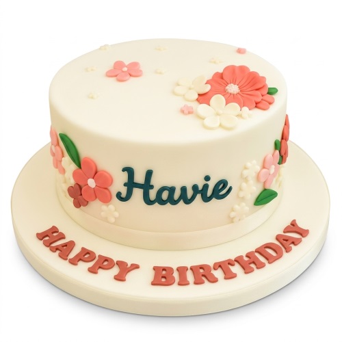 Round white birthday cake with coral, pink, and white fondant flowers and a personalised name.