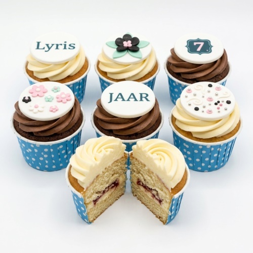 Set of floral and decorative birthday cupcakes with custom age and name toppers.