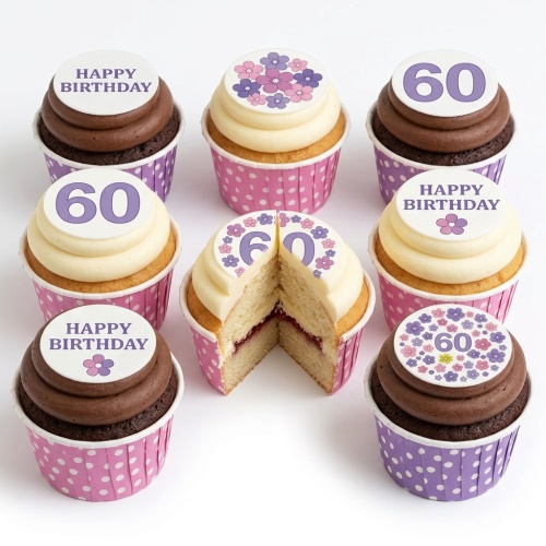 Assortment of floral and 'Happy Birthday' cupcakes with a custom age topper in pink and purple polka dot cases.
