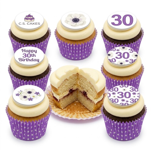 Close-up of floral and custom age birthday cupcakes in purple polka dot wrappers