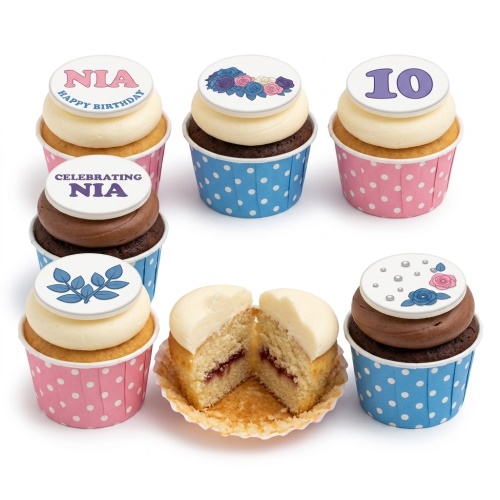 Assortment of personalised floral birthday cupcakes with custom name and age toppers.