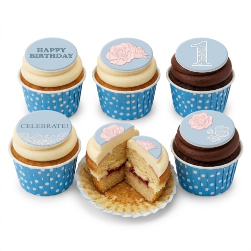 Six cupcakes with blue polka dot wrappers, light blue toppers, pink roses, white lace, and 'Happy Birthday' message.