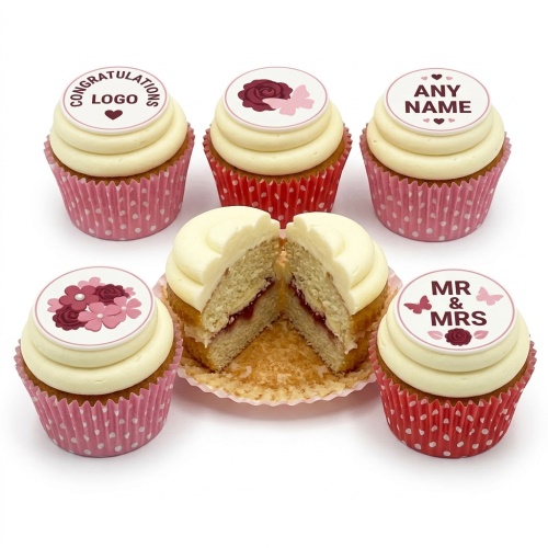Six cupcakes with white frosting, floral toppers, and custom messages like "Mr & Mrs".