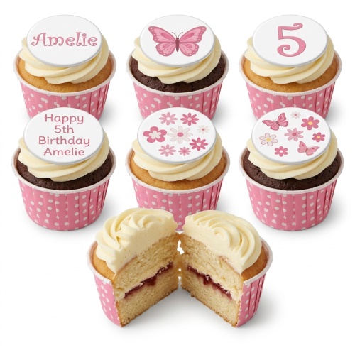 Set of personalised butterfly and floral birthday cupcakes with custom age and name toppers, in pink polka dot cases.