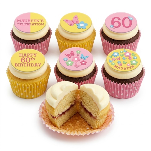 A selection of floral and butterfly themed birthday cupcakes with pink and yellow toppers and white frosting.