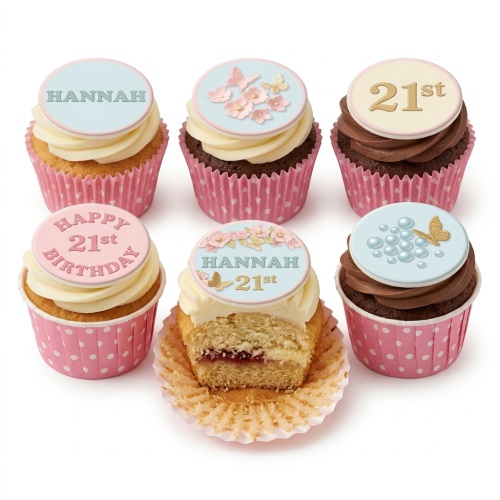 Set of six elegant cupcakes with pink and blue edible toppers, featuring flowers, butterflies, and bubbles, some with custom age and name examples.