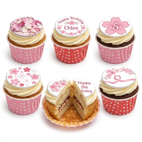Six cupcakes with pink and white cherry blossom toppers, some with custom age and name.