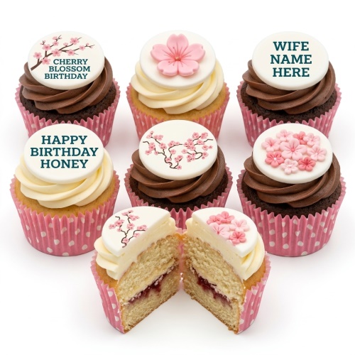 A collection of cherry blossom themed birthday cupcakes with pink and white frosting, some with edible floral toppers and custom messages.
