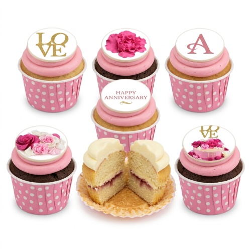 Pink and white anniversary cupcakes with floral designs, 'LOVE' and 'Happy Anniversary' toppers.