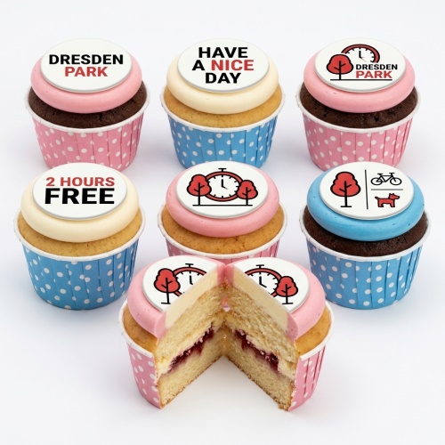 Cupcakes with park theme toppers including trees, a clock, a bicycle, and a dog.