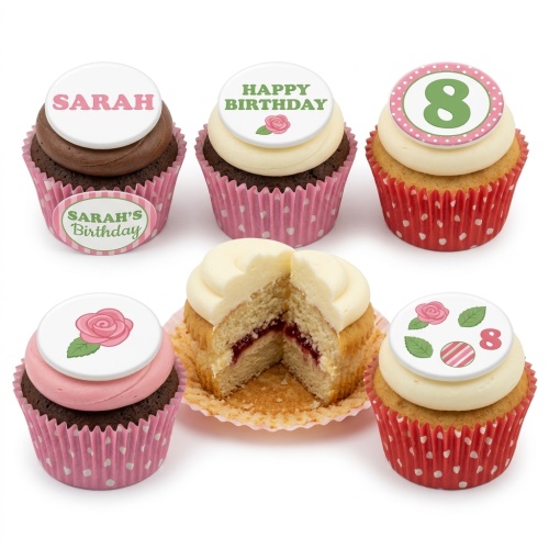 A set of floral birthday cupcakes with pink and red wrappers, featuring rose decorations and a custom age topper.