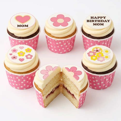 Six floral and heart themed cupcakes in pink wrappers, with "MOM" and "HAPPY BIRTHDAY MOM" messages.