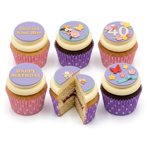 Six cupcakes with pastel purple, pink, and yellow floral and butterfly decorations, some with custom age and message toppers.