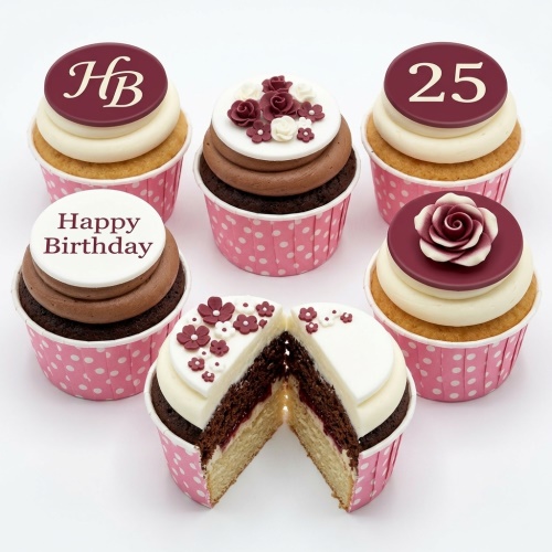 Elegant floral birthday cupcakes with custom age and "Happy Birthday" toppers in pink polka dot wrappers.