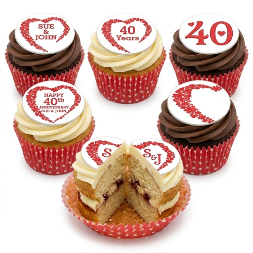 Assortment of anniversary cupcakes with red heart toppers and custom text examples on vanilla and chocolate frosting.