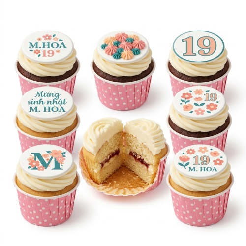 White and pink floral birthday cupcakes with custom age and initial toppers.