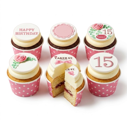 Set of six floral birthday cupcakes with pink polka dot cases, some with rose decorations, 'Happy Birthday' message, and custom age '15' toppers.
