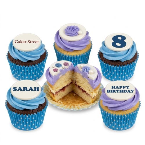 Assortment of blue and purple cupcakes with custom age, personalised name, and 'Happy Birthday' message toppers, featuring floral and swirl decorations.