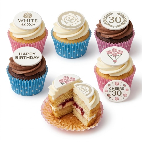 Assortment of floral and birthday themed cupcakes with custom age and message toppers.