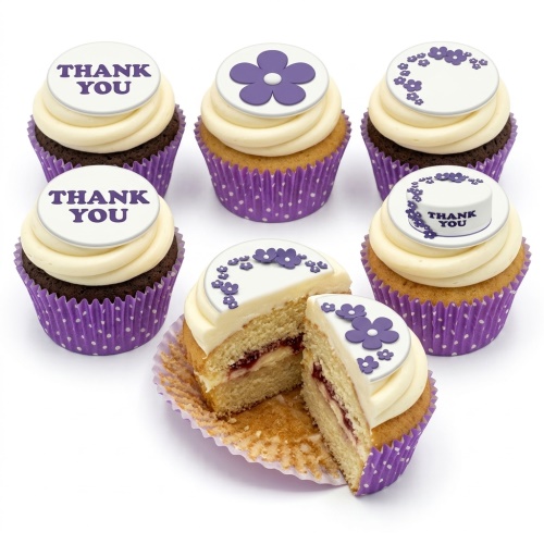 Assortment of floral cupcakes with purple flower designs and 'Thank You' messages on white toppers.