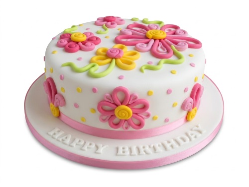 White round cake with pink and yellow fondant flowers, green swirls, and polka dots.