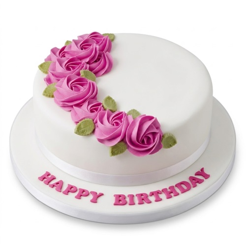 White round birthday cake with a cascade of pink piped roses and green leaves, with 'Happy Birthday' written on the cake board.