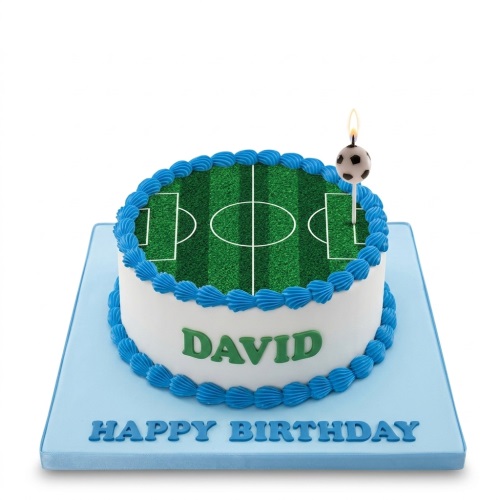 Round white birthday cake with edible football pitch top, blue piping, and football candle.