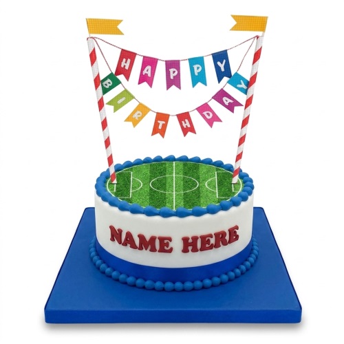 Round white football pitch birthday cake with blue base and 'Happy Birthday' banner topper.