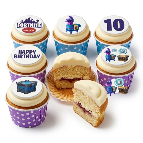 Fortnite themed cupcakes with white frosting, blue and purple polka dot wrappers, and edible toppers featuring Fortnite logo, Llama, treasure chest, V-bucks, and a number 10.