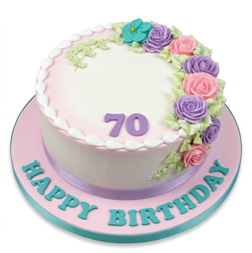 Round floral birthday cake with pink and purple sugar roses, green leaves, and a custom age topper.