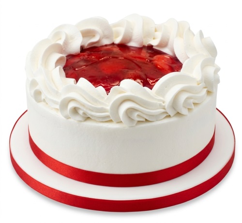 Round fresh cream cake with red fruit topping, white cream swirls, and a red ribbon.