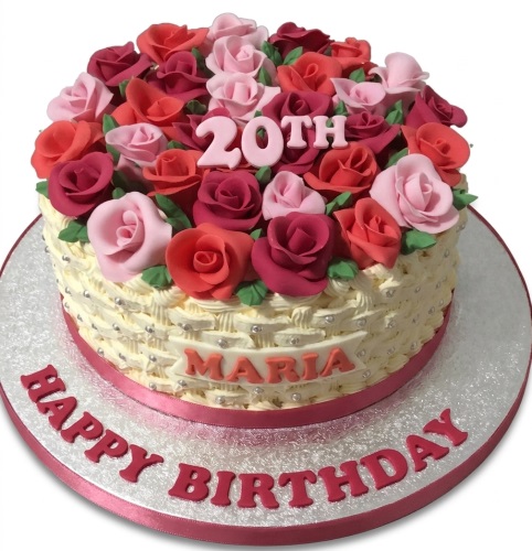 Round birthday cake with pink and red roses, basketweave side, and custom age topper.