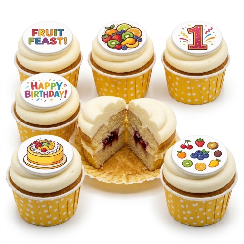 A selection of cupcakes with white frosting and yellow polka dot wrappers, topped with colourful fruit designs, a 'Happy Birthday!' message, and a custom age topper.