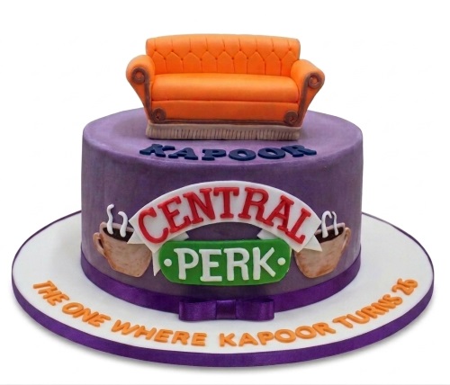 Round purple Friends TV Show birthday cake with orange couch, Central Perk logo, and custom message.