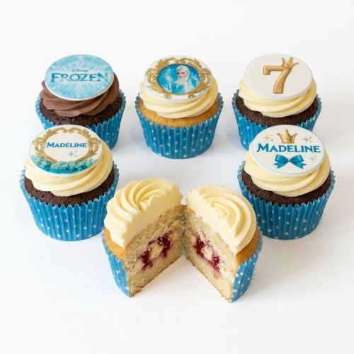 Disney Frozen themed cupcakes with Elsa, Frozen logo, custom age '7', and personalised name toppers.