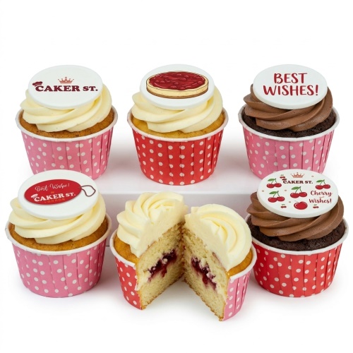 Six cupcakes with white and brown frosting, decorated with pink and red polka dot wrappers and themed toppers including a cherry cheesecake, cherries, and 'Best Wishes' messages.