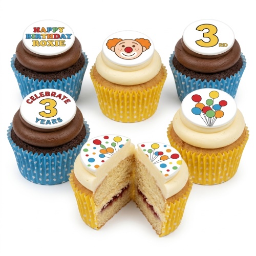 Assortment of birthday cupcakes with clown, balloons, and custom age toppers in blue and yellow cases.