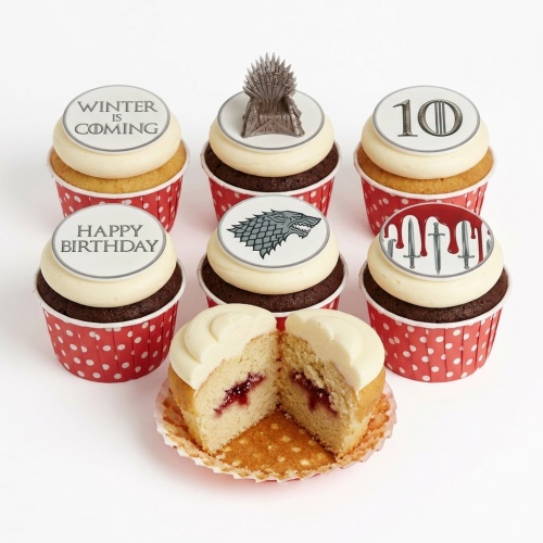 Set of Game of Thrones themed cupcakes with Iron Throne, Direwolf, 'Winter is Coming', 'Happy Birthday', and custom age toppers.