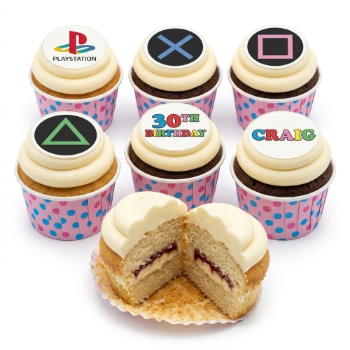 Cupcakes with PlayStation logo and controller symbols, with custom age and personalised name toppers, in pink polka dot cases.