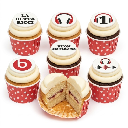 Cupcakes with red and black headphone, sound wave, and 'b' logo toppers, in red polka dot wrappers.