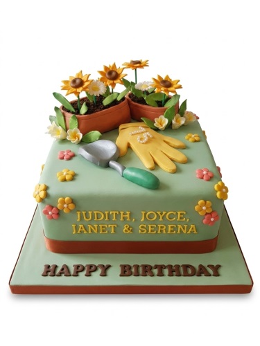 Light green rectangular birthday cake with edible sunflowers, gardening glove, and trowel decorations.