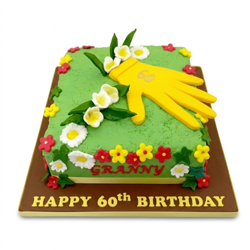 Rectangular green cake with yellow gardening glove, white and red flowers, and custom age message.