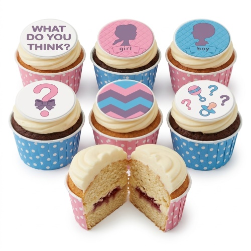 Assorted gender reveal cupcakes with pink and blue toppers, including 'What do you think?', question marks, and baby silhouettes. One cupcake is cut open revealing pink filling.