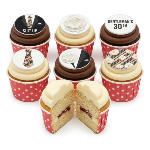 Cupcakes with suit, tie, and plaid designs, some with white sugar flowers and a custom age topper.