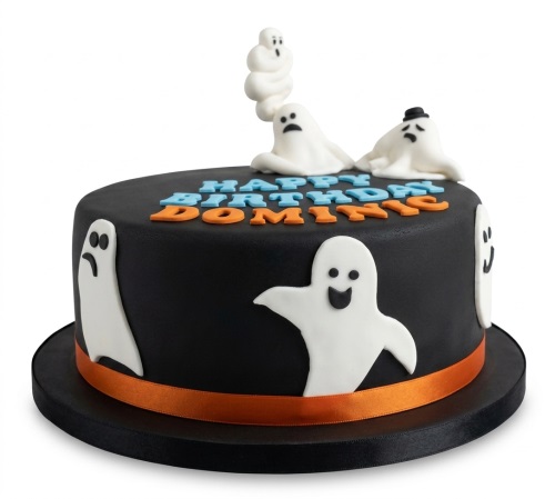 Round black birthday cake with white ghost decorations and a 'Happy Birthday' message.
