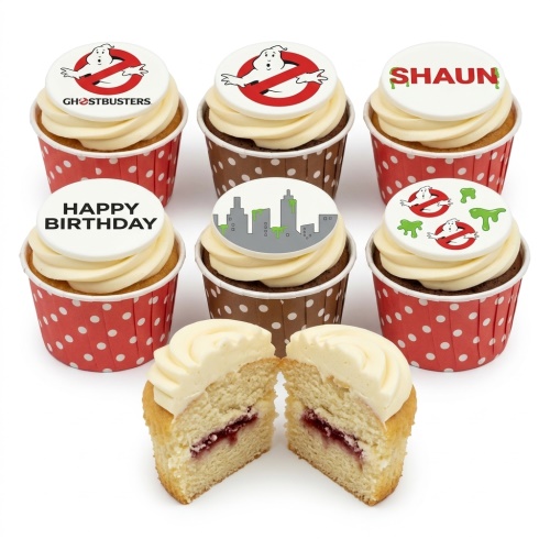 Ghostbusters themed cupcakes with logo, city skyline, and slime toppers, some with 'Happy Birthday' and a name.